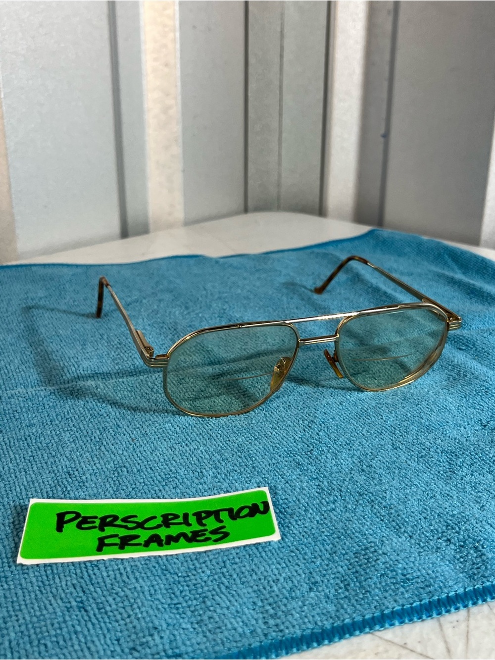 Gold Metal Prescription Eyeglass Frames with Green-Tinted Lenses